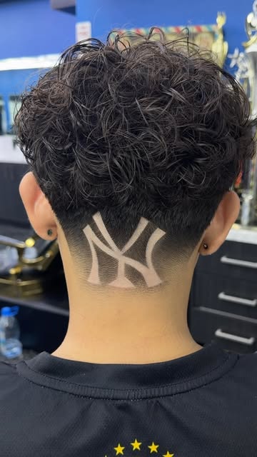 Detailed New York Yankees hair design at the back of a fresh taper