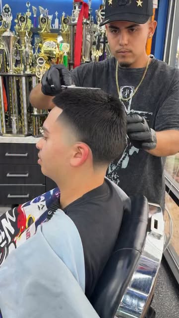 Toro refining a clean fade in the barber chair